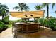 Outdoor bar with seating and lighting amid lush landscaping at 915 Seaside Dr # 613 Weeks 32-33, Sarasota, FL 34242
