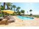 Resort style pool with sun loungers and palm trees at 915 Seaside Dr # 613 Weeks 32-33, Sarasota, FL 34242