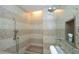Walk-in shower featuring decorative tile work, multiple shower heads, and a built-in seat at 915 Seaside Dr # 613 Weeks 32-33, Sarasota, FL 34242