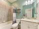 Full bathroom with granite countertop, tub, shower, and tiled walls at 10015 Marbella Dr, Bradenton, FL 34211