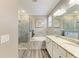 Bathroom with a walk in shower, soaking tub, and granite countertops at 10015 Marbella Dr, Bradenton, FL 34211
