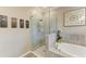 Shower with a walk in shower and a soaking tub at 10015 Marbella Dr, Bradenton, FL 34211