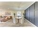Dining area situated between living room and modern accent wall, featuring stylish furnishings and natural light at 10015 Marbella Dr, Bradenton, FL 34211