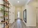Well-lit entryway with hardwood floors, decorative shelving, and a view of the glass front door at 10015 Marbella Dr, Bradenton, FL 34211