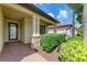 Inviting front porch with brick accents, stylish columns, and manicured hedges at 10015 Marbella Dr, Bradenton, FL 34211