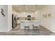 Bright kitchen features white cabinets, granite countertops, stainless steel appliances, and an island with seating at 10015 Marbella Dr, Bradenton, FL 34211