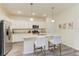 Bright kitchen features white cabinets, granite countertops, stainless steel appliances, and an island with seating at 10015 Marbella Dr, Bradenton, FL 34211