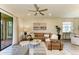 Cozy living room with a large sectional sofa, decorative pillows, and sliding glass doors to the lanai at 10015 Marbella Dr, Bradenton, FL 34211
