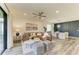Bright living room featuring a brown leather sectional and stylish decor at 10015 Marbella Dr, Bradenton, FL 34211