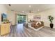 View of the living room showing a leather sofa and sliding glass doors to the patio at 10015 Marbella Dr, Bradenton, FL 34211
