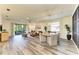 Spacious living room features a comfortable seating area, access to the screened lanai, and stylish decor at 10015 Marbella Dr, Bradenton, FL 34211