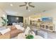 Open-concept living space with a leather sofa, dining area, and kitchen at 10015 Marbella Dr, Bradenton, FL 34211