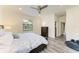 Comfortable main bedroom with a ceiling fan and large window overlooking the well manicured yard at 10015 Marbella Dr, Bradenton, FL 34211