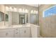 Elegant bathroom with dual sinks, quartz counters, and a glass-enclosed tiled shower at 10054 Cross River Trl, Parrish, FL 34219