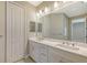 Large bathroom with dual sinks, white cabinets, quartz counters and a large mirror at 10054 Cross River Trl, Parrish, FL 34219