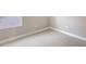 Bedroom with neutral walls, white baseboards, carpet flooring, and bright window at 10054 Cross River Trl, Parrish, FL 34219
