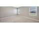 Bright bedroom features neutral carpet, natural light from two large windows, and fresh neutral paint at 10054 Cross River Trl, Parrish, FL 34219