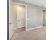Neutral-toned bedroom with plush carpet, white trim, and an entrance to the bathroom at 10054 Cross River Trl, Parrish, FL 34219