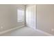 Neutral bedroom features plush carpet, bi-fold closet doors, and a window for natural light at 10054 Cross River Trl, Parrish, FL 34219