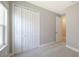 Bedroom features neutral walls, plush carpet, and closet with bi-fold doors at 10054 Cross River Trl, Parrish, FL 34219