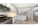 Spacious modern kitchen with stainless steel appliances, white cabinets, and tile floors at 10054 Cross River Trl, Parrish, FL 34219