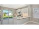 Open kitchen with white cabinets, stone countertops, and stainless steel appliances at 10054 Cross River Trl, Parrish, FL 34219