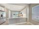Bright kitchen features stainless steel appliances, quartz counters, and backyard view at 10054 Cross River Trl, Parrish, FL 34219