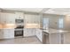 Chef's kitchen features stainless appliances, white cabinets, and quartz countertops at 10054 Cross River Trl, Parrish, FL 34219