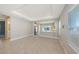Open living area features tile floors, recessed lighting, and a seamless flow into the adjacent kitchen at 10054 Cross River Trl, Parrish, FL 34219