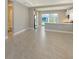The main living area showcasing tile flooring and an open floor plan with a kitchen view at 10054 Cross River Trl, Parrish, FL 34219