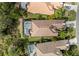 An aerial view of a home and a screen enclosed pool in a neighborhood with manicured landscaping at 11716 Strandhill Ct, Lakewood Ranch, FL 34202