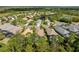 Aerial view of neighborhood homes with backyard pools surrounded by lush trees and landscaping at 11716 Strandhill Ct, Lakewood Ranch, FL 34202