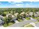 Beautiful aerial view of several homes with lush green lawns near a serene lake at 11716 Strandhill Ct, Lakewood Ranch, FL 34202