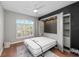 Bedroom featuring an open Murphy bed, closet, and hardwood floors, perfect for a guest room at 11716 Strandhill Ct, Lakewood Ranch, FL 34202