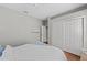 Neutral bedroom with light walls, hardwood floors, ceiling fan and large white closet at 11716 Strandhill Ct, Lakewood Ranch, FL 34202