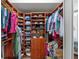 Walk-in closet with custom wood shelving, drawers, and hanging rods, providing ample storage space at 11716 Strandhill Ct, Lakewood Ranch, FL 34202