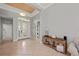 Bright foyer with double doors, tile flooring, console table, and a tray ceiling with unique detailing at 11716 Strandhill Ct, Lakewood Ranch, FL 34202