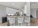 The kitchen is equipped with stainless steel appliances, granite countertops, and ample cabinet space, complemented by bar seating at 11716 Strandhill Ct, Lakewood Ranch, FL 34202