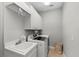 Functional laundry room with sink, cabinetry, and modern washer and dryer appliances for efficient chores at 11716 Strandhill Ct, Lakewood Ranch, FL 34202