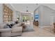 Spacious living room with large sectional sofa, stylish decor, and views of the lanai at 11716 Strandhill Ct, Lakewood Ranch, FL 34202