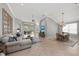 Open-concept living and dining area featuring tiled floors, large windows, and stylish furnishings at 11716 Strandhill Ct, Lakewood Ranch, FL 34202