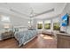 Light-filled main bedroom with tray ceiling, hardwood floors, and bay windows at 11716 Strandhill Ct, Lakewood Ranch, FL 34202