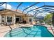 Captivating pool and patio area with a mix of seating and grilling space under a screen enclosure at 11716 Strandhill Ct, Lakewood Ranch, FL 34202