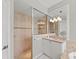 Walk-in shower featuring a glass enclosure, tiled walls, and dual shower heads, adjacent to a dual sink vanity at 11716 Strandhill Ct, Lakewood Ranch, FL 34202