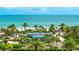 Beautiful beachside condo complex with swimming pool and lush tropical landscaping at 1211 Gulf Of Mexico Dr # 309, Longboat Key, FL 34228