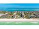 Aerial view of condo community on beachfront, with a beautiful ocean view and a well-manicured lawn at 1211 Gulf Of Mexico Dr # 309, Longboat Key, FL 34228