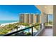Expansive balcony with stunning views of the pool, beach, and ocean, perfect for relaxing and entertaining at 1211 Gulf Of Mexico Dr # 309, Longboat Key, FL 34228