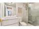 Bright bathroom with a standing glass shower and a white floating vanity at 1211 Gulf Of Mexico Dr # 309, Longboat Key, FL 34228