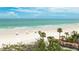 Beautiful sandy beach with palm trees and pristine turquoise water at 1211 Gulf Of Mexico Dr # 309, Longboat Key, FL 34228