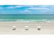 Relaxing beach scene with white sand, turquoise water, and sun umbrellas at 1211 Gulf Of Mexico Dr # 309, Longboat Key, FL 34228